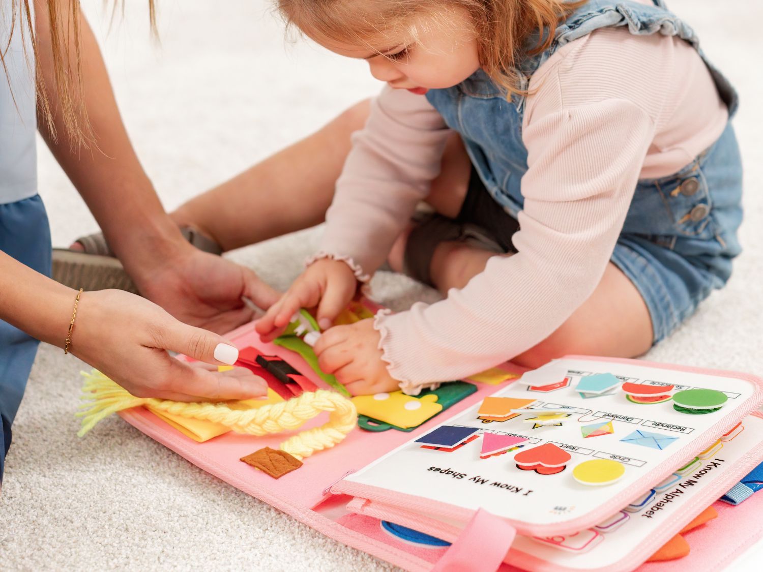 Travel-friendly backpack: A toddler activity backpack with a quiet book and busy board, perfect for travel with sensory learning activities.